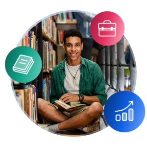 Un étudiant international portant des vêtements d’été est assis les jambes croisées sur le sol d’une bibliothèque du campus, tenant un livre.